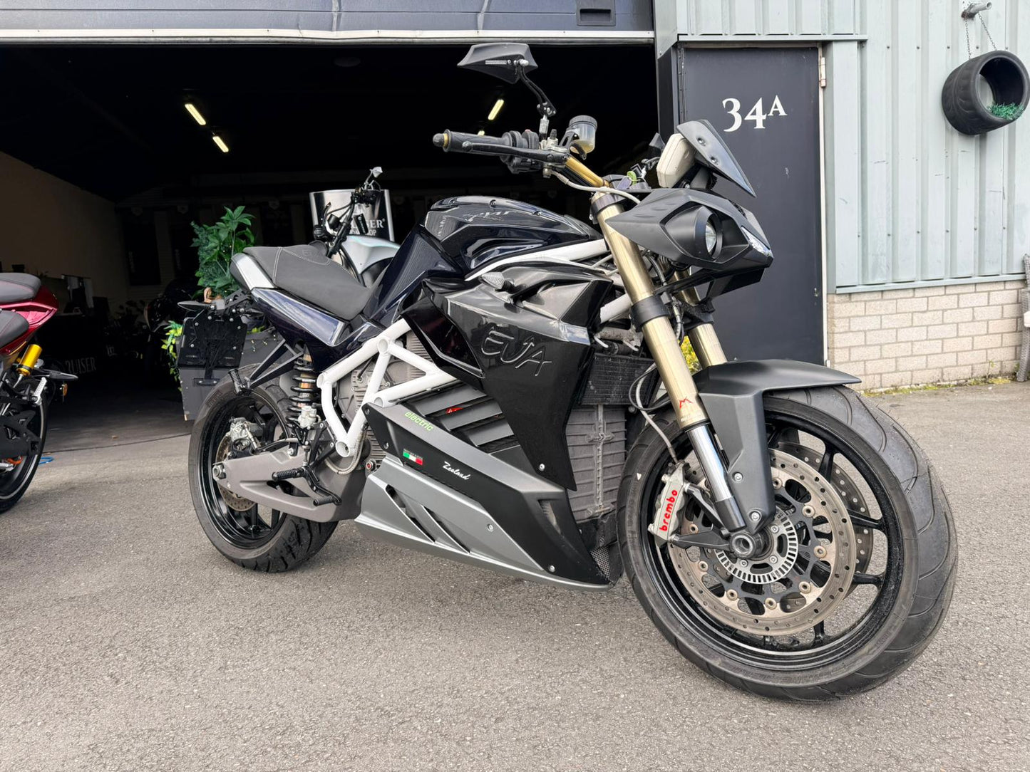 Energica EVA R elektrische motorfiets, zwart, geparkeerd voor garage